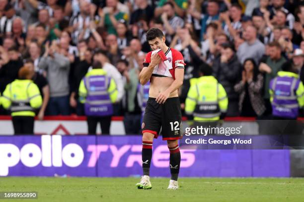 John Egan of Sheffield United reacts after Newcastle United scored their sides eighth goal during the Premier League match between Sheffield United...