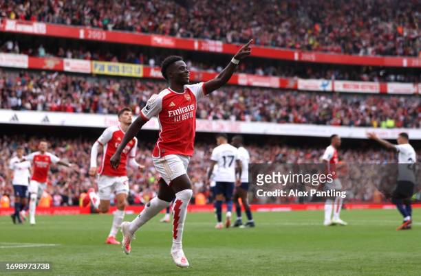 Bukayo Saka of Arsenal celebrates after scoring his sides second goal during the Premier League match between Arsenal FC and Tottenham Hotspur at...