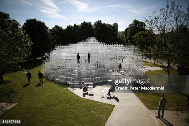 Visitors interact with the Serpentine Gallery Pavilion on June 4, 2013 in London, England. Designed by Japanese architect Sou Fujimoto, it occupies...