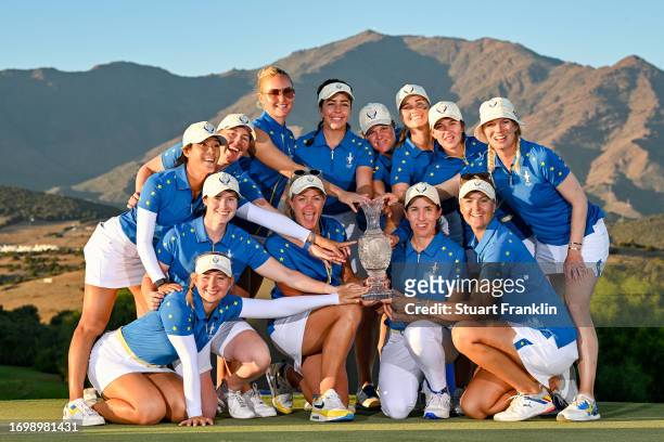 Team Europe poses for a group photo with the Solheim Cup after defeating Team USA during Day Three of The Solheim Cup at Finca Cortesin Golf Club on...