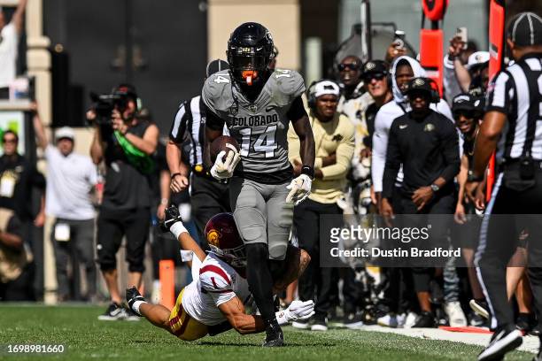 Omarion Miller of the Colorado Buffaloes is tackled by cornerback Domani Jackson of the USC Trojans after a catch in the fourth quarter at Folsom...