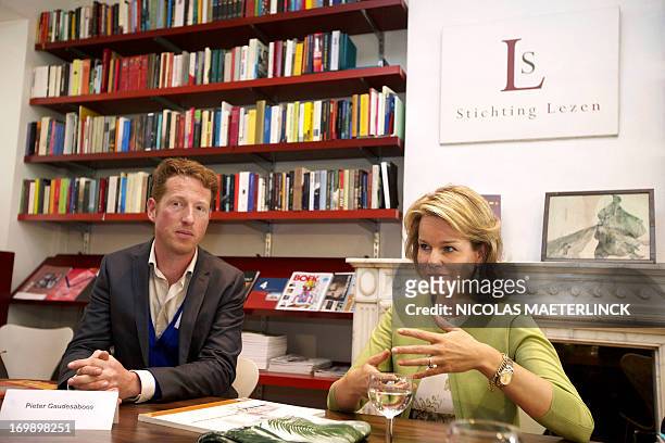 Princess Mathilde of Belgium , with author Pieter Gaudesaboos, speaks during a royal visit to the 'Stichting Lezen' on the occasion of the 'Het Jaar...