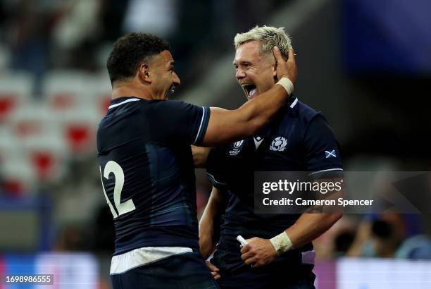 Darcy Graham of Scotland celebrates with Sione Tuipulotu of Scotland after scoring his team's seventh try during the Rugby World Cup France 2023...