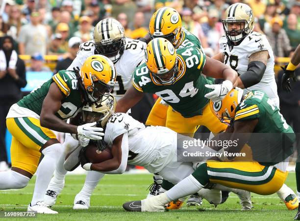 Darnell Savage of the Green Bay Packers, Karl Brooks of the Green Bay Packers, and Quay Walker of the Green Bay Packers tackle Kendre Miller of the...