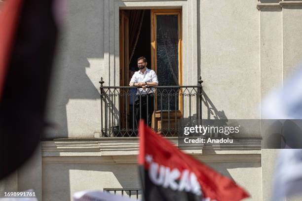 President Gabriel Boric observes from his presidential office a demonstration in his supporters citizens gather in front of the La Moneda...