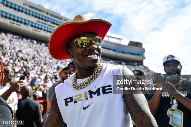 Rapper Jonathan "DaBaby" Lyndale Kirk smiles while attending a game between the Colorado Buffaloes and the USC Trojans at Folsom Field on September...