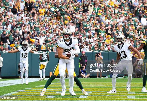 Jimmy Graham of the New Orleans Saints catches a touchdown during the first quarter against the Green Bay Packers at Lambeau Field on September 24,...