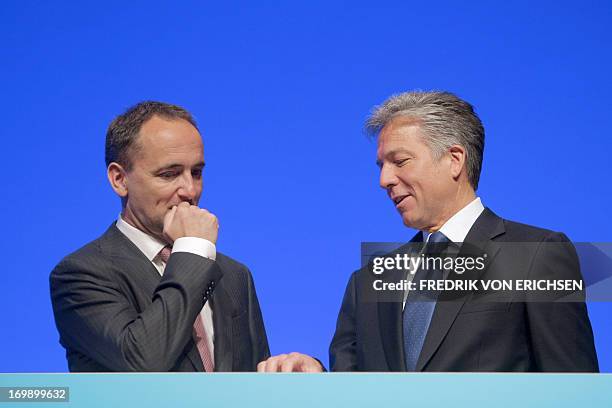 Spokesmen of the manging board of German business software giant SAP Bill McDermott and Jim Hagemann Snabe stand behind the company's logo during a...