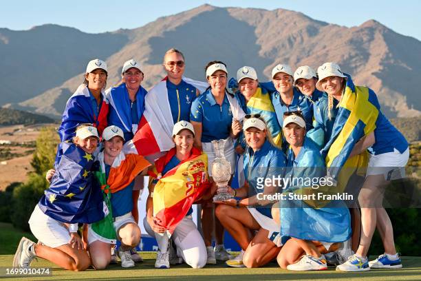 Team Europe poses for a group photo with the Solheim Cup after defeating Team USA during Day Three of The Solheim Cup at Finca Cortesin Golf Club on...