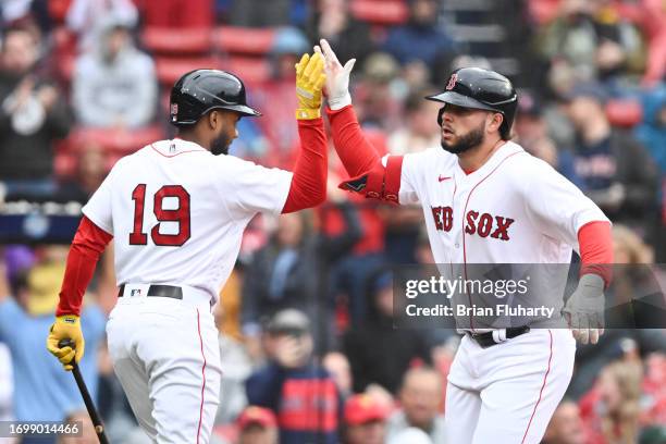 Wilyer Abreu of the Boston Red Sox high-fives Pablo Reyes after hitting a solo home run against the Chicago White Sox during the second inning at...