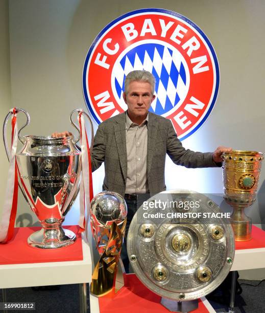 Bayern Munich's head coach Jupp Heynckes poses with four trophy's after giving his farewell press conference in Munich, southern Germany, on June 4,...