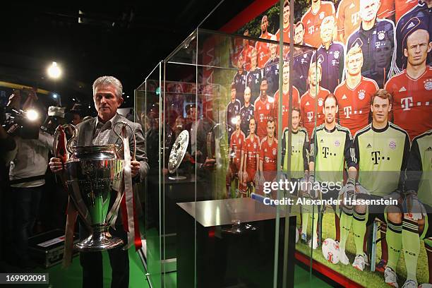 Head coach Jupp Heynckes of FC Bayern Muenchen places the UEFA Champions League winners trophy in Bayern Muenchen interactive club museum after a...