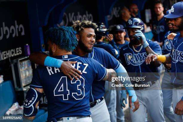 Junior Caminero hugs Harold Ramirez of the Tampa Bay Rays to celebrate Ramirez's two-run home run in the fifth inning of their MLB game against the...