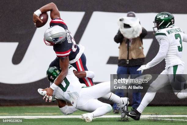 Pharaoh Brown of the New England Patriots is tackled by Adrian Amos of the New York Jets in the first half of a game at MetLife Stadium on September...