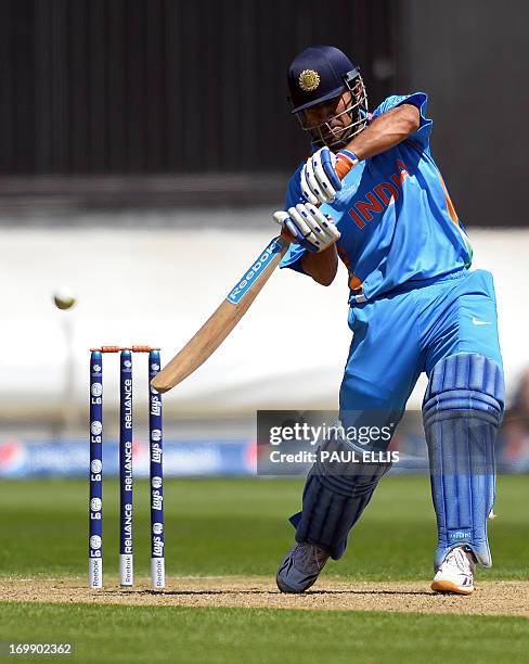 India's captain Mahendra Singh Dhoni plays a shot during the warm-up cricket match ahead of the 2013 ICC Champions Trophy between India and Australia...