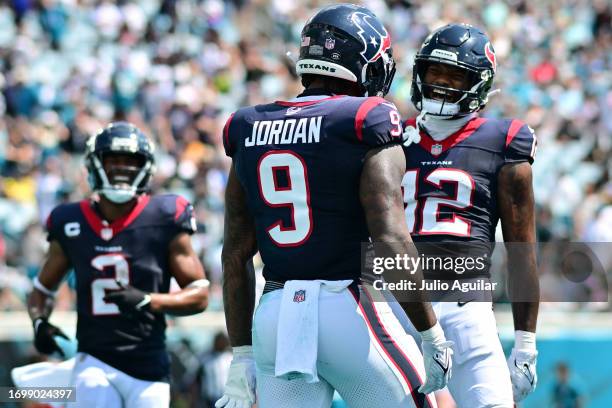 Brevin Jordan of the Houston Texans celebrates his touchdown with Nico Collins during the second quarter of a game against the Jacksonville Jaguars...