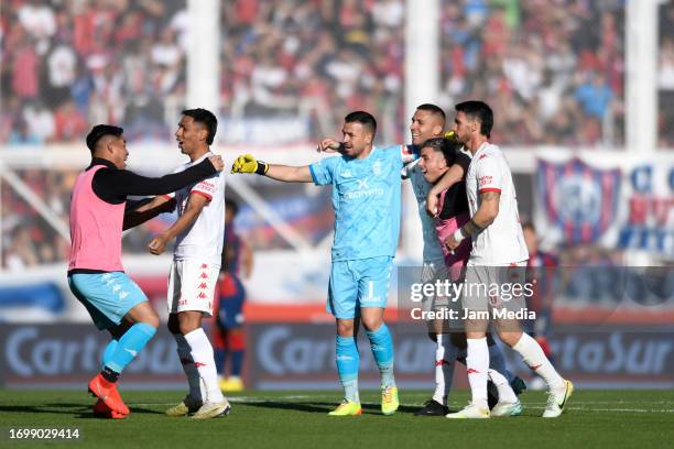 Lucas Carrizo and Lucas Chavez of Huracan celebrate the team's first goal scored by Ignacio Pussetto during a match between San Lorenzo and Huracan...