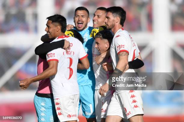 Lucas Carrizo and Lucas Chavez of Huracan celebrate the team's first goal scored by teammate Ignacio Pussetto during a match between San Lorenzo and...