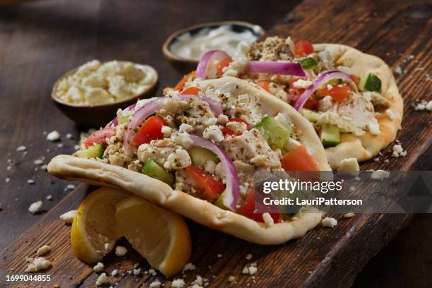 chicken souvlaki gyro with tzatziki sauce - feta stockfoto's en -beelden