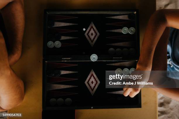 two people playing backgammon - backgammon stock pictures, royalty-free photos & images