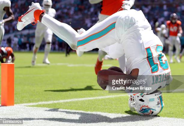 Raheem Mostert of the Miami Dolphins dives into the the end zone while scoring a rushing touchdown during the second quarter against the Denver...