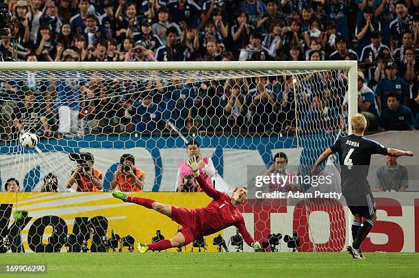 Keisuke Honda of Japan scores a penalty goal in the FIFA World Cup qualifier match between Japan and Australia at Saitama Stadium on June 4, 2013 in...
