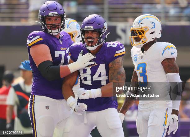 Ezra Cleveland of the Minnesota Vikings and Josh Oliver of the Minnesota Vikings celebrate after Oliver's receiving touchdown during the second...