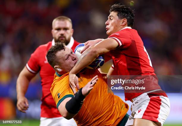 Angus Rees Angus Bell of Australia is tackled by Louis Rees-Zammit of Wales ...