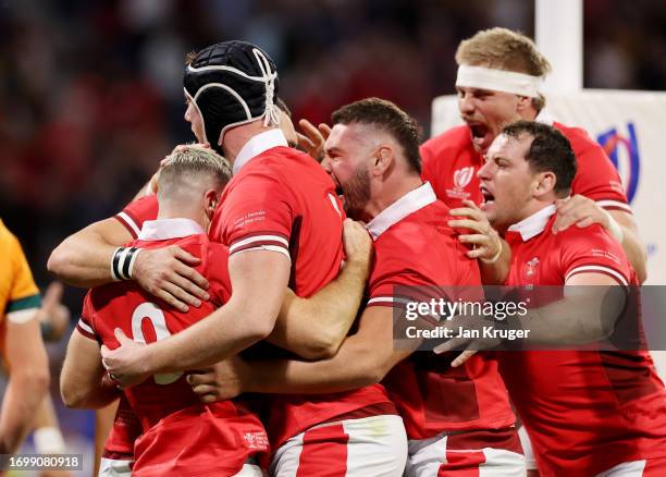 Gareth Davies of Wales celebrates with teammates after scoring his team's first try during the Rugby World Cup France 2023 match between Wales and...