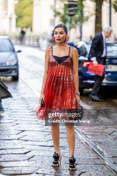 Karina Nigay wears red transparent dress outside The Attico during the Milan Fashion Week - Womenswear Spring/Summer 2024 on September 23, 2023 in...