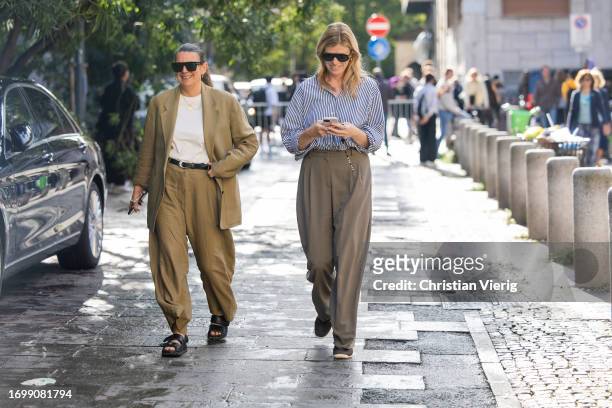 Guest wears beige blazer, pants and a guest wears brown pants outside Bally during the Milan Fashion Week - Womenswear Spring/Summer 2024 on...
