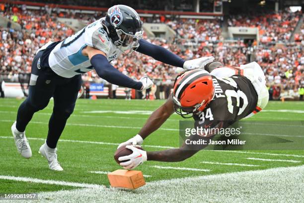 Jerome Ford of the Cleveland Browns dives for a touchdown against Jack Gibbens of the Tennessee Titans during the third quarter of a game at...
