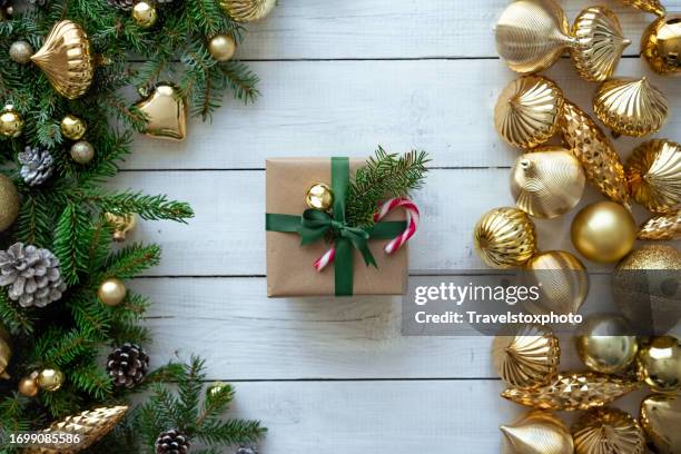 christmas gift with green bow. merry christmas background. overhead view, christmas table, evergreens, candy cane. white wooden table. xmas background. for invitation card or website banner. for christmas newsletter banner. for greeting card. - centre piece stock pictures, royalty-free photos & images