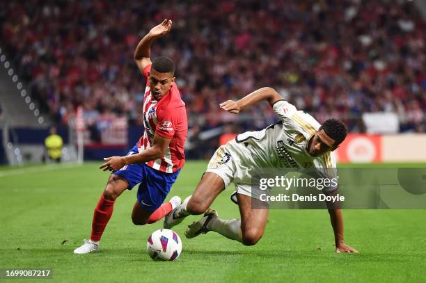 Samuel Lino of Atletico Madrid battles for possession with Jude Bellingham of Real Madrid during the LaLiga EA Sports match between Atletico Madrid...