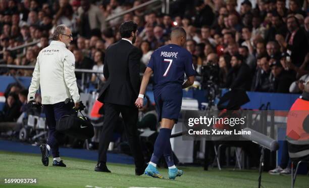 Kylian Mbappe of Paris Saint-Germain reacts after his injury during the Ligue 1 Uber Eats match between Paris Saint-Germain and Olympique de...