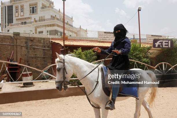 Yemeni girl learns to ride a horse at an equestrian club on August 03, 2023 in Sana'a, Yemen. Nine years of war and a humanitarian crisis in Yemen’s...
