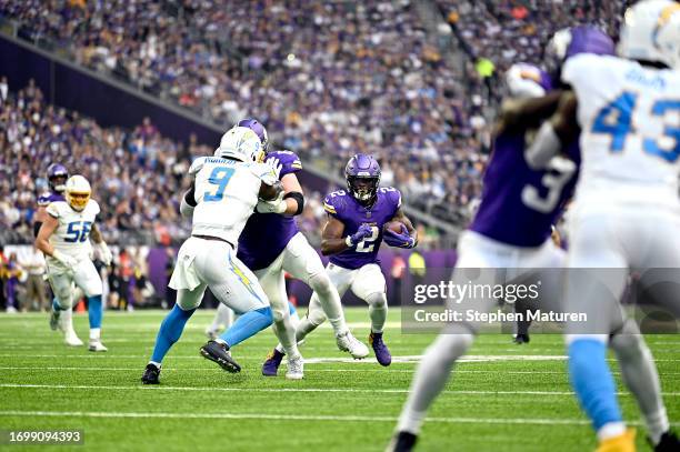 Alexander Mattison of the Minnesota Vikings runs the ball during the third quarter against the Los Angeles Chargers at U.S. Bank Stadium on September...