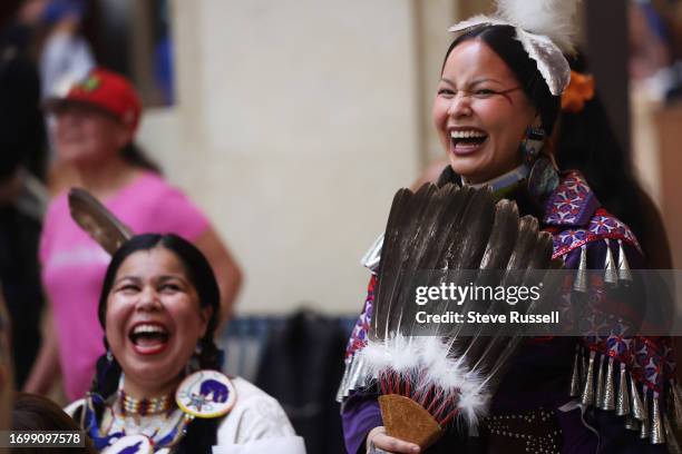 Aerial Sunday-Cardinal from Goodfish Lake in Alberta, right, shares a laugh with Lena Recollet from Wikwemikong on Manitoulin Island as they watch...