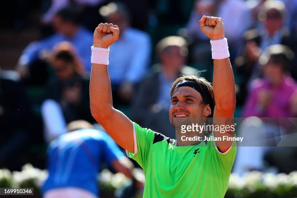 David Ferrer of Spain celebrates match point in his Men's Singles quarter final match against Tommy Robredo of Spain during day ten of the French...