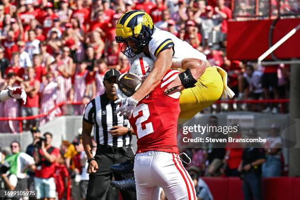 Roman Wilson of the Michigan Wolverines catches a touchdown pass against Isaac Gifford of the Nebraska Cornhuskers in the first quarter at Memorial...