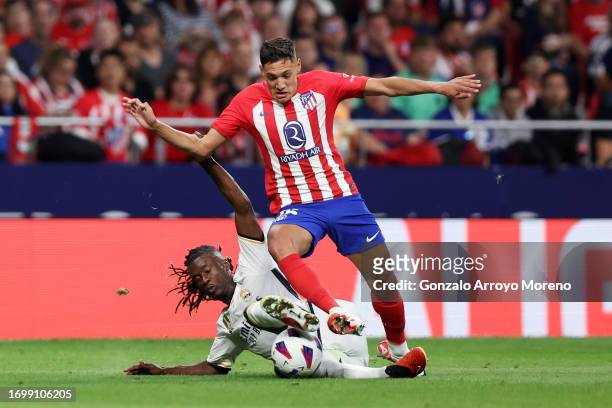 Eduardo Camavinga of Real Madrid tackles Nahuel Molina of Atletico Madrid during the LaLiga EA Sports match between Atletico Madrid and Real Madrid...