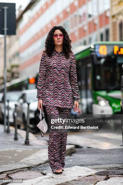 Guest wears a purple jacket with geometric printed patterns, purple transparent sunglasses, outside Missoni, during the Milan Fashion Week -...