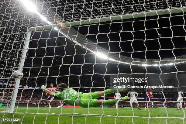 Antoine Griezmann of Atletico Madrid scores the team's second goal past Kepa Arrizabalaga of Real Madrid during the LaLiga EA Sports match between...
