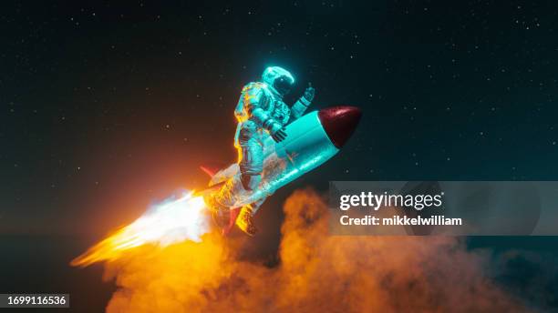 astronaut rockets into space atop a blazing launch - missile flame stock pictures, royalty-free photos & images