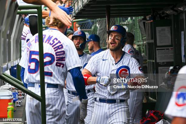 Patrick Wisdom of the Chicago Cubs is congratulated by teammates in the dugout following a two-run home run during the sixth inning against the...