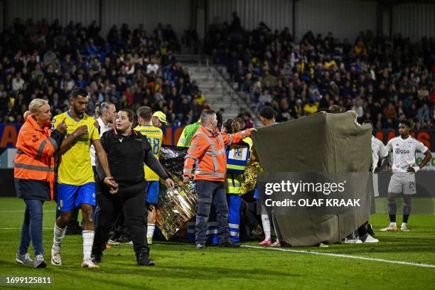 Waalwijk's Dutch goalkeeper Etienne Vaessen receives medical assistance after he collapsed during the Dutch Eredivisie match between RKC Waalwijk and...