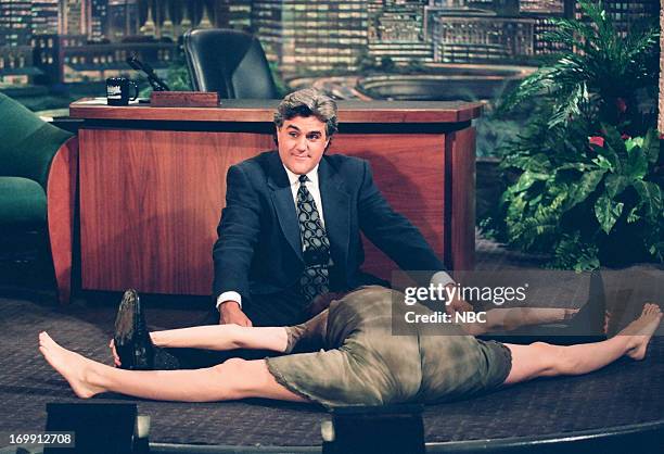 Episode 509 -- Pictured: Actress Sean Young does the splits during an interview with host Jay Leno on August 01, 1994--
