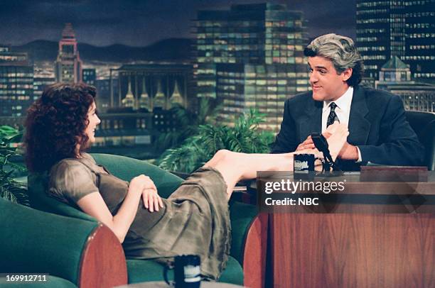 Episode 509 -- Pictured: Actress Sean Young puts her feet on the desk during an interview with host Jay Leno on August 01, 1994--