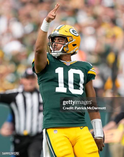 Jordan Love of the Green Bay Packers signals for a first down during the fourth quarter against the New Orleans Saints at Lambeau Field on September...