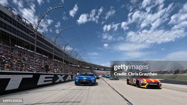 Bubba Wallace, driver of the McDonald's Toyota, and Chris Buescher, driver of the Fastenal Ford, lead the field on a pace lap prior to the NASCAR Cup...